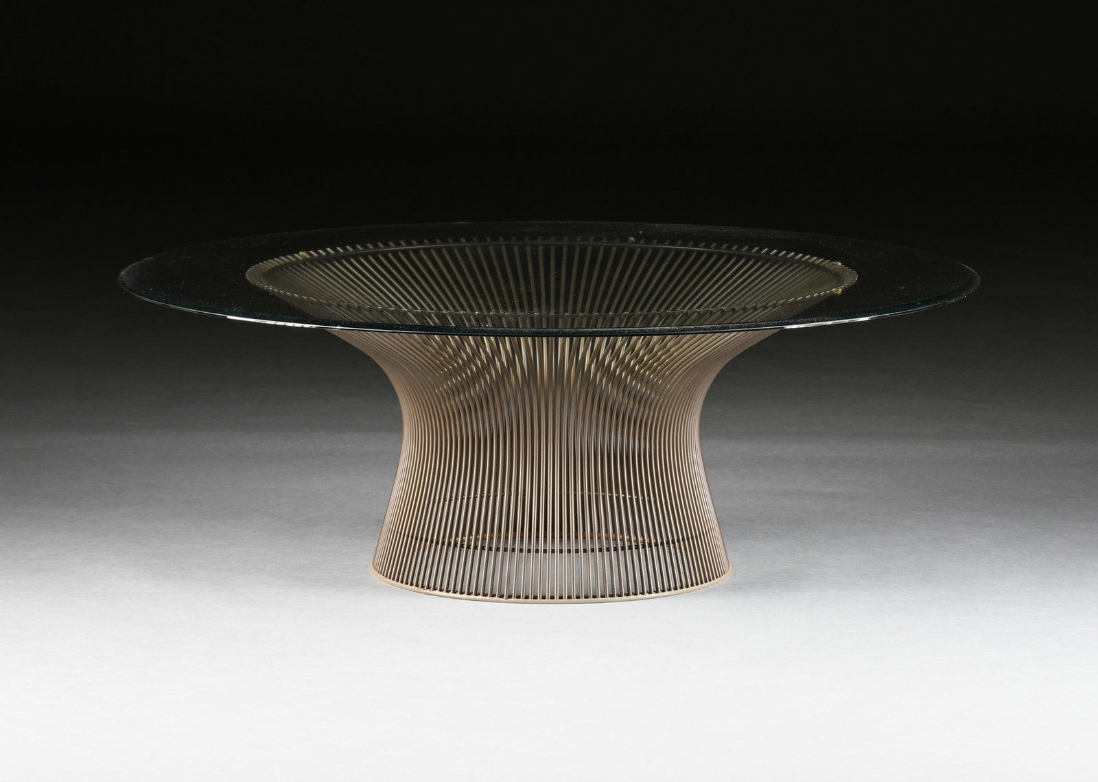 A MID-CENTURY MODERN ROUND COFFEE TABLE, CIRCA 1970,: A MID-CENTURY MODERN ROUND COFFEE TABLE, CIRCA 1970, round glass topped coffee table with a steel base in the style of the American designer Warren Platner. 14 1/2 x 42 in. (36.8 x 106.7 cm.) Provenan
