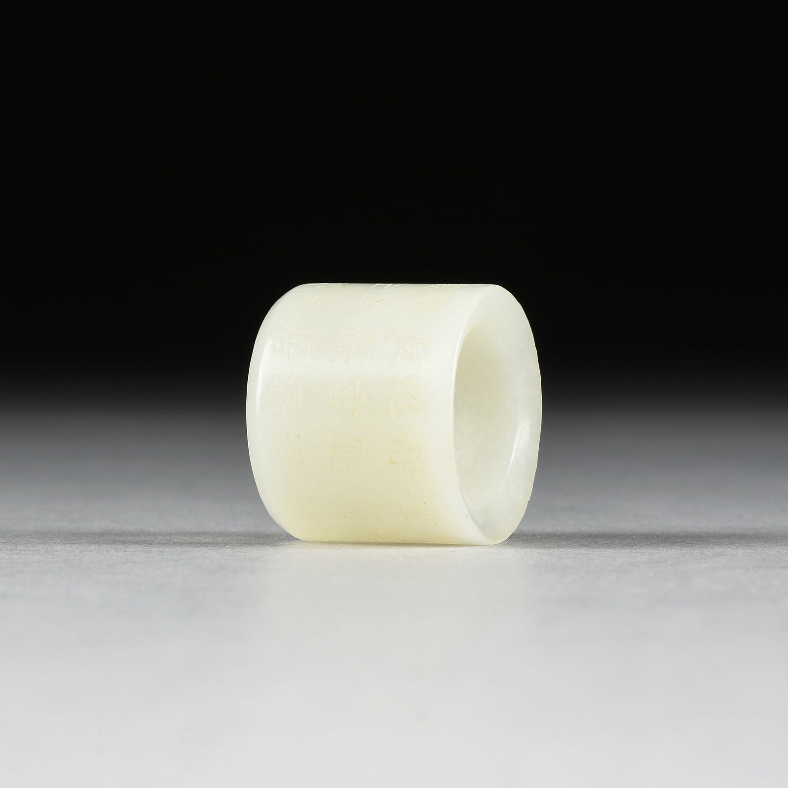 A JADE ARCHER'S RING, CHINESE,: A JADE ARCHER'S RING, CHINESE, a carved jade ring used for archery and inscribed in the round with Chinese characters. View 360° … 1 1/8 x 1 3/8 in. (2.9 x 3.5 cm.) Provenance: Private