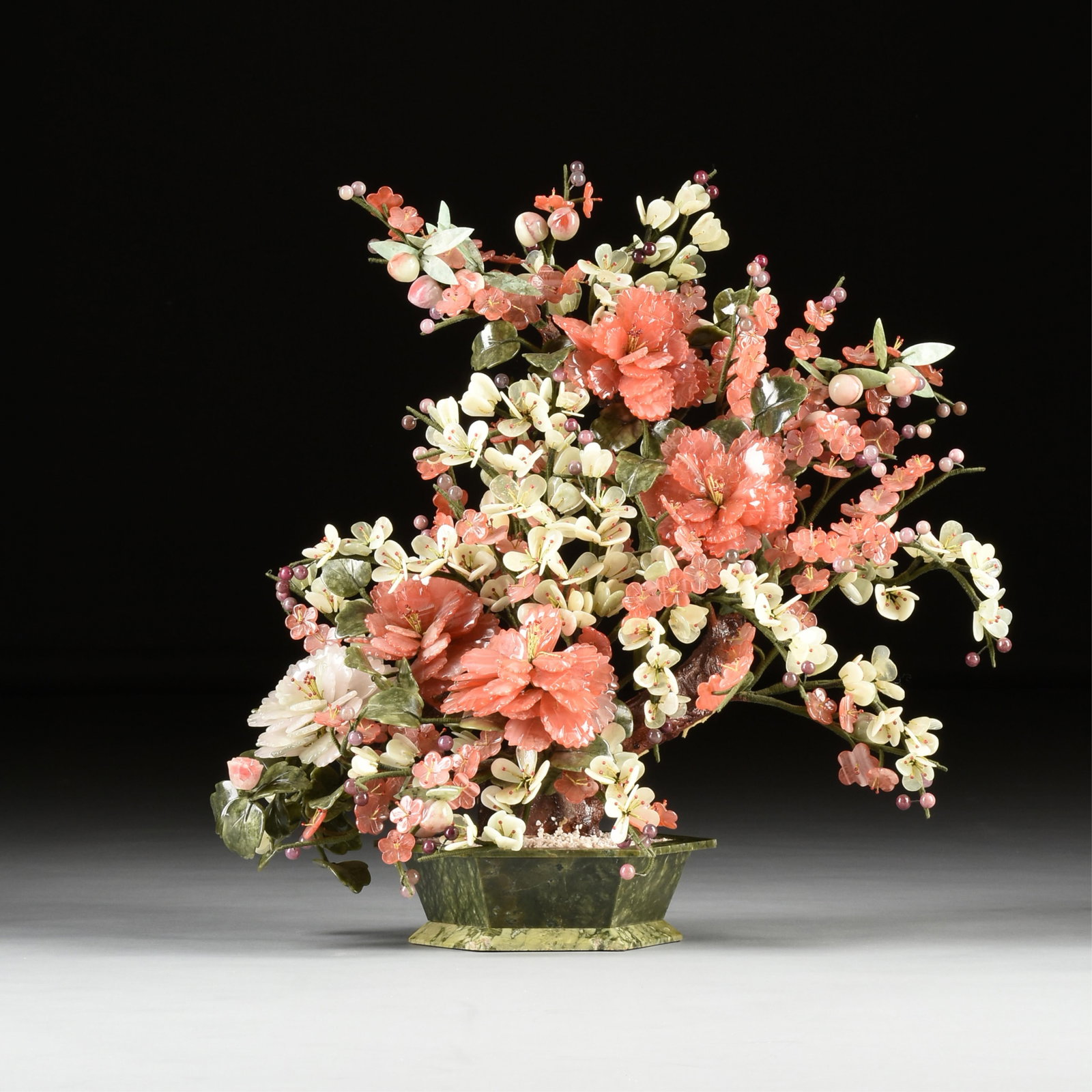 A FLORAL SCULPTURE, CHINESE, 20TH CENTURY,: A FLORAL SCULPTURE, CHINESE, 20TH CENTURY, glass petal and leaves mounted on paper wrapped wire attached to a brown painted support on a green hexagonal base. 25 x 25 x 15 in. (63.5 x 63.5 x 38.1 cm.)