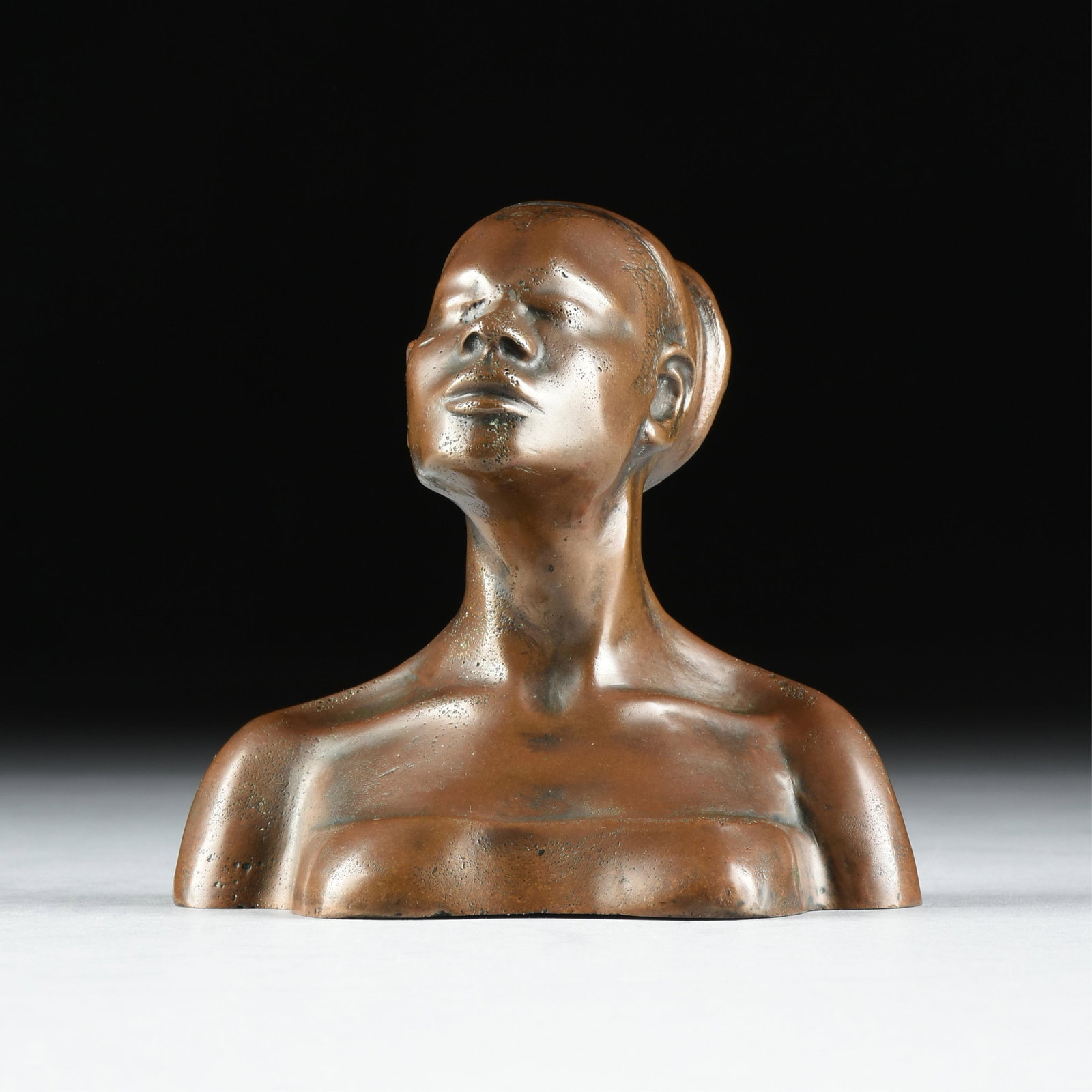 VALENTINE FRANCIS SHUSTER (Russian/American 1901-1958) A Mangbetu Woman, 1948,: VALENTINE FRANCIS SHUSTER (Russian/American 1901-1958) A Mangbetu Woman, 1948, patinated bronze bust sculpture, signed and dated on lower back, "SHUSTER '48." 5 1/2 x 6 x 4 in. (14 x 15.2 x 10.2 cm.) 