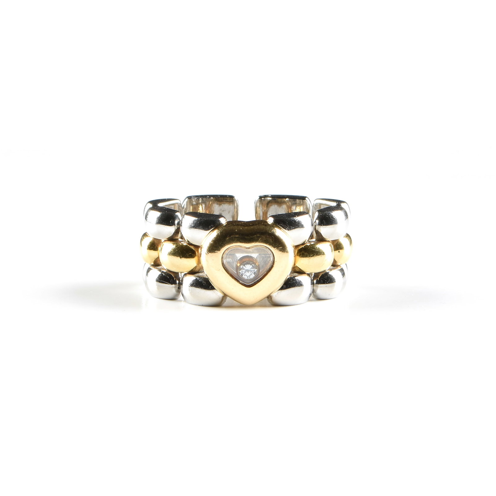 A CHOPARD 18K GOLD, STAINLESS STEEL, AND DIAMOND RING, SWISS,: A CHOPARD 18K GOLD, STAINLESS STEEL, AND DIAMOND RING, SWISS, 18k yellow gold and stainless steel band made of articulated links, with a 0.03 carat round brilliant diamond (E-F, VSI-VS2) floating bene