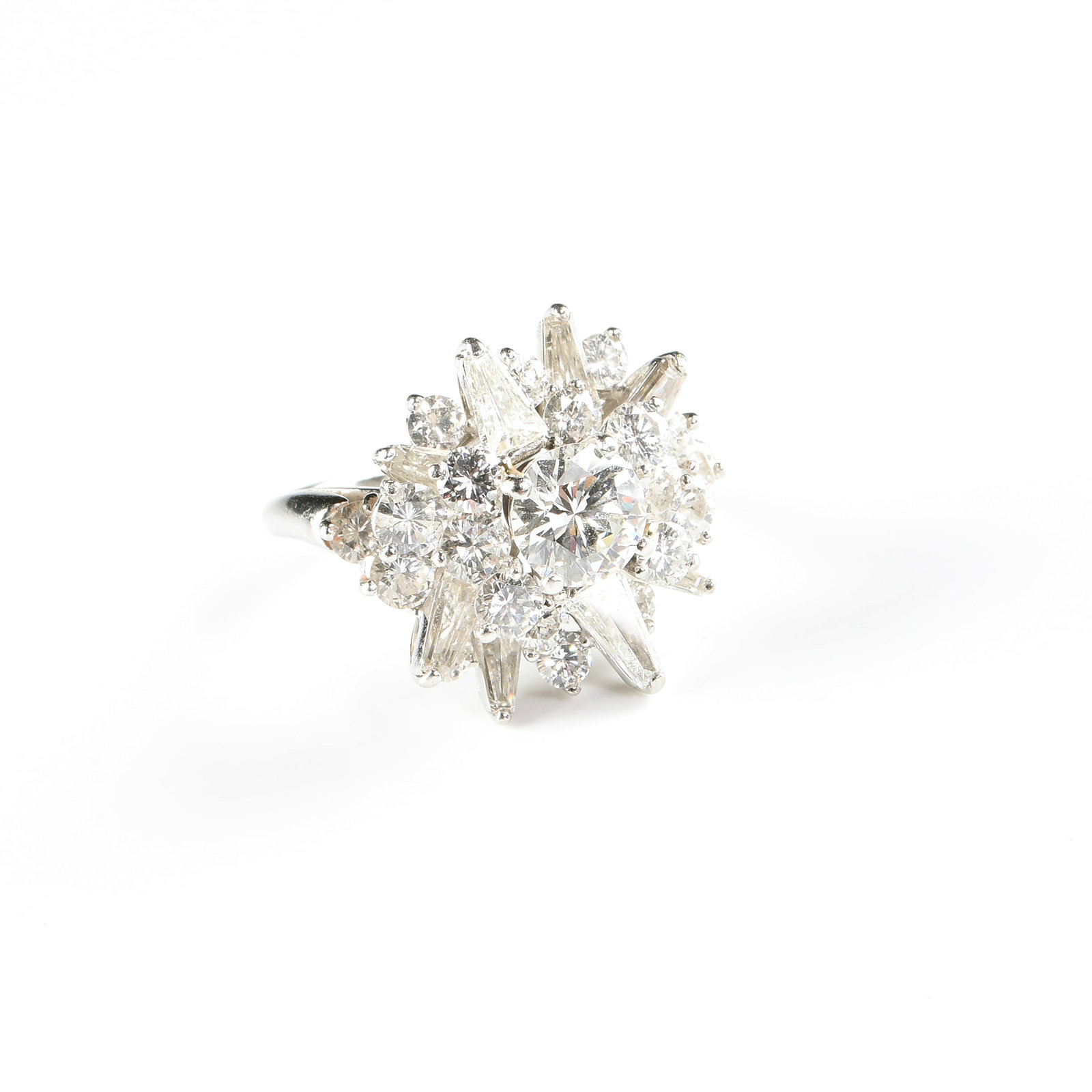 A PLATINUM AND DIAMOND CLUSTER RING,: A PLATINUM AND DIAMOND CLUSTER RING, platinum ring centered with a 1.22 carat round brilliant cut diamond (SI2) with a faint blue fluorescence, surrounded by accent diamonds in a starburst pattern, in
