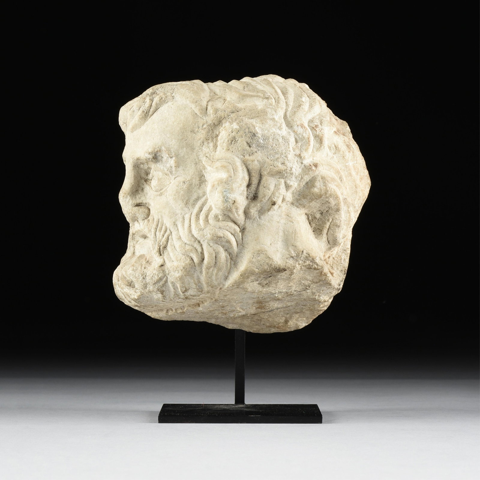 A ROMAN IMPERIAL HEAD OF A BARBARIAN, 3RD CENTURY,: A ROMAN IMPERIAL HEAD OF A BARBARIAN, 3RD CENTURY, a high relief sculpted marble head from a sculptural frieze or panel. 8 x 8 x 5 1/4 in. (20.3 x 20.3 x 13.3 cm.), With stand: 10 1/4 x 8 x 6 1/4 in. 