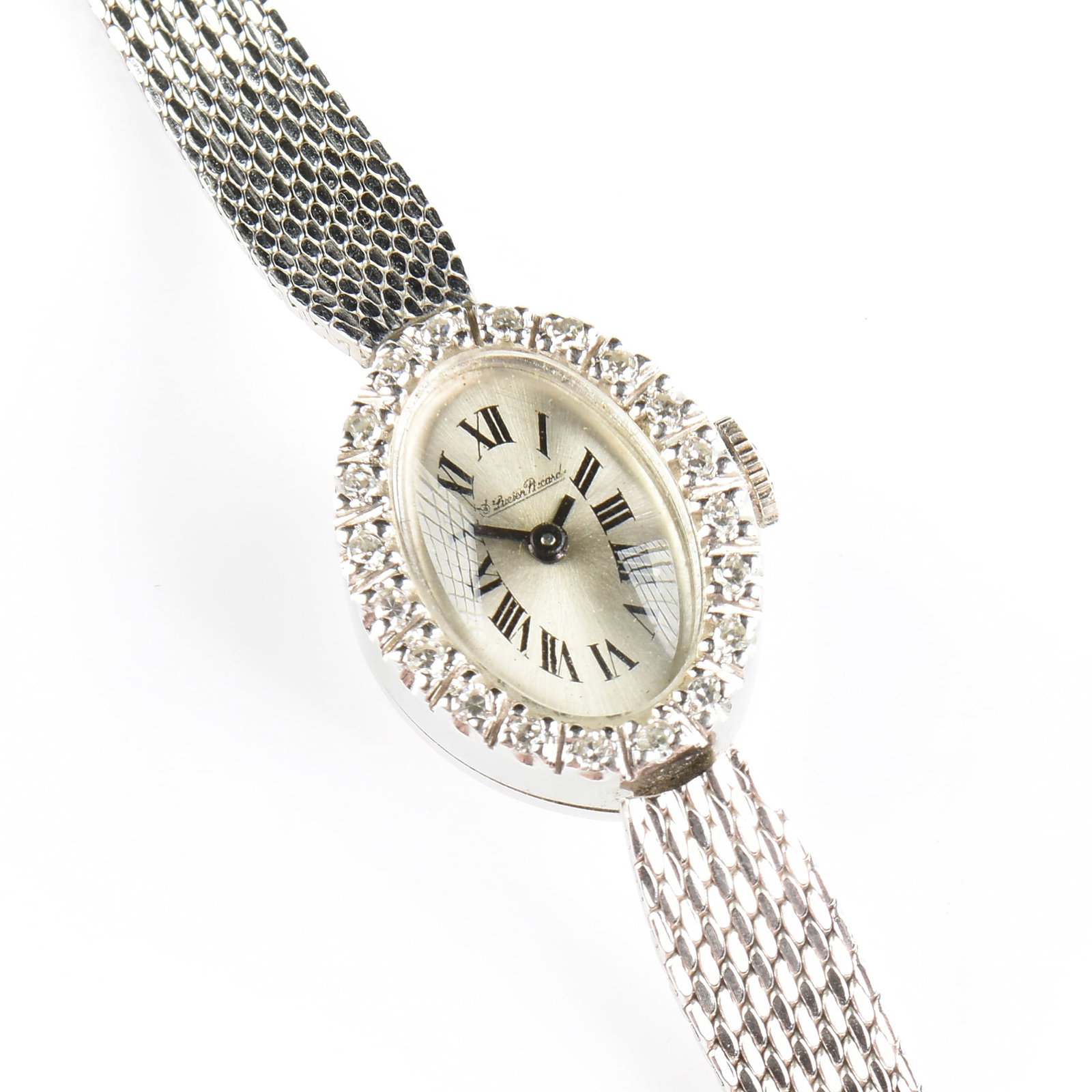 A LUCIEN PICCARD 14K GOLD AND DIAMOND WATCH,: A LUCIEN PICCARD 14K GOLD AND DIAMOND WATCH, 14k white gold watch case with silvered dial and manual wind movement, accented with bezel set diamonds totaling approximately 0.2 carats (G-H, VS), mounte