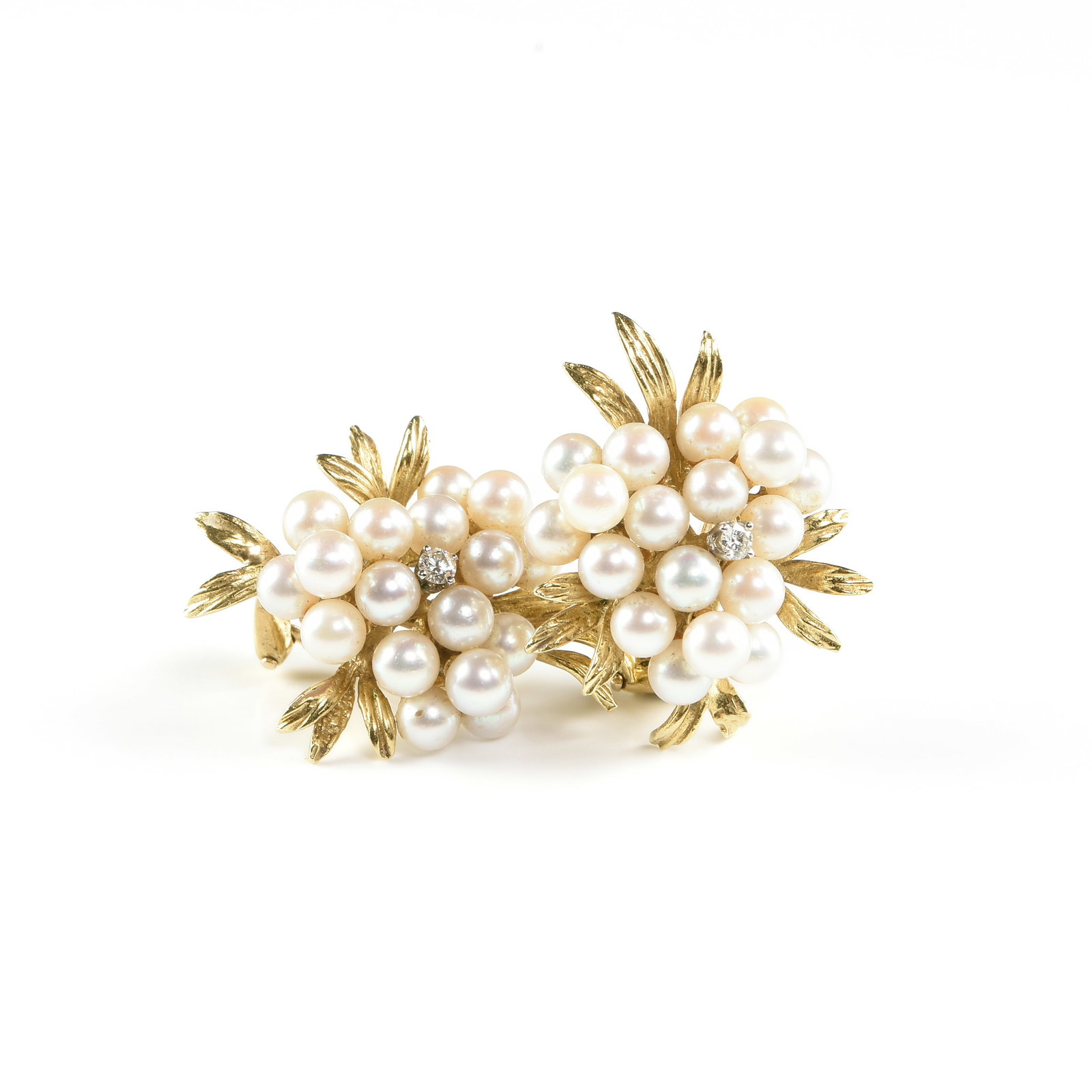 A PAIR OF 18K GOLD, PEARL, AND DIAMOND EARRINGS,: A PAIR OF 18K GOLD, PEARL, AND DIAMOND EARRINGS, 18k yellow gold clip back earrings, each set with a cluster of eighteen pearls (approx. 4.2 mm each) surrounding a single round diamond (approx. 0.9