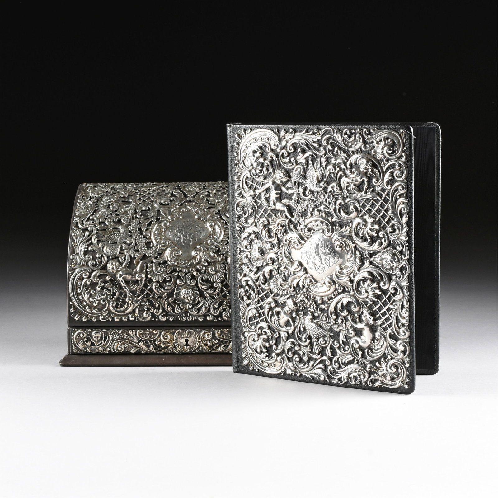 A TWO-PIECE STERLING SILVER AND LEATHER DESKTOP SET, AMERICAN, CIRCA 1900,: A TWO-PIECE STERLING SILVER AND LEATHER DESKTOP SET, AMERICAN, CIRCA 1900, two-piece matching set comprised of a stationary box with hinged lid and a portfolio, each wrapped in black leather and