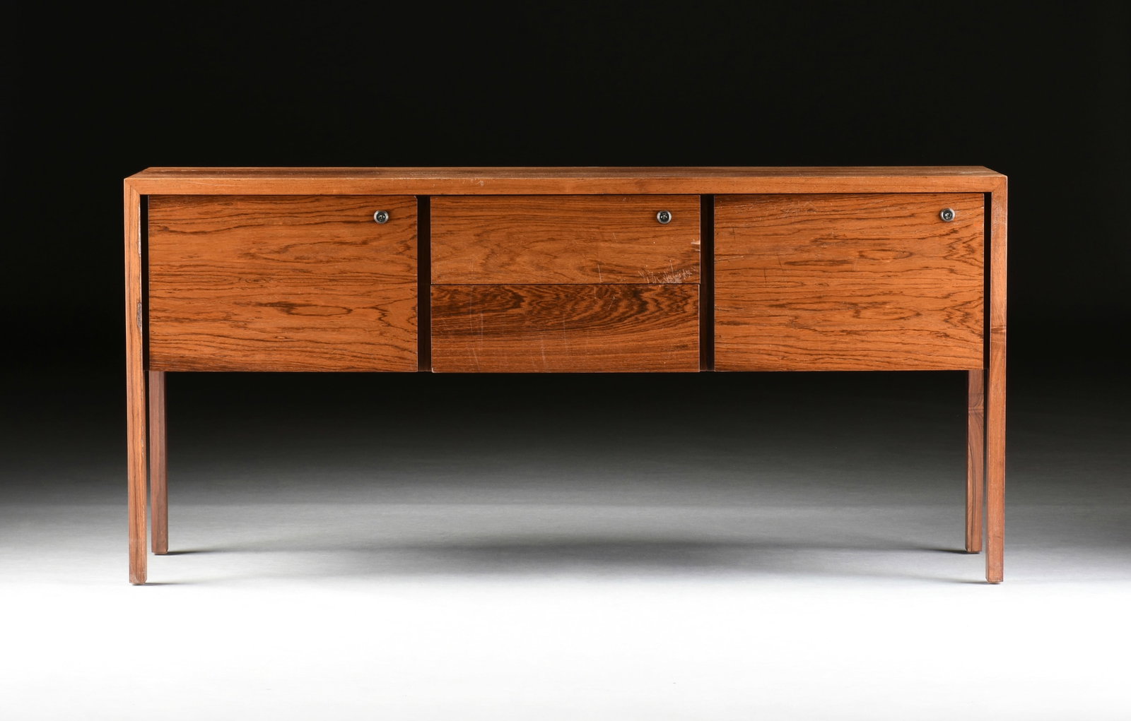A HARVEY PROBBER CREDENZA FILING CABINET, AMERICAN, CIRCA 1970,: A HARVEY PROBBER CREDENZA FILING CABINET, AMERICAN, CIRCA 1970, mid-century modern walnut credenza with four locking drawers, including two filing cabinets and two smaller center drawers, and with mak