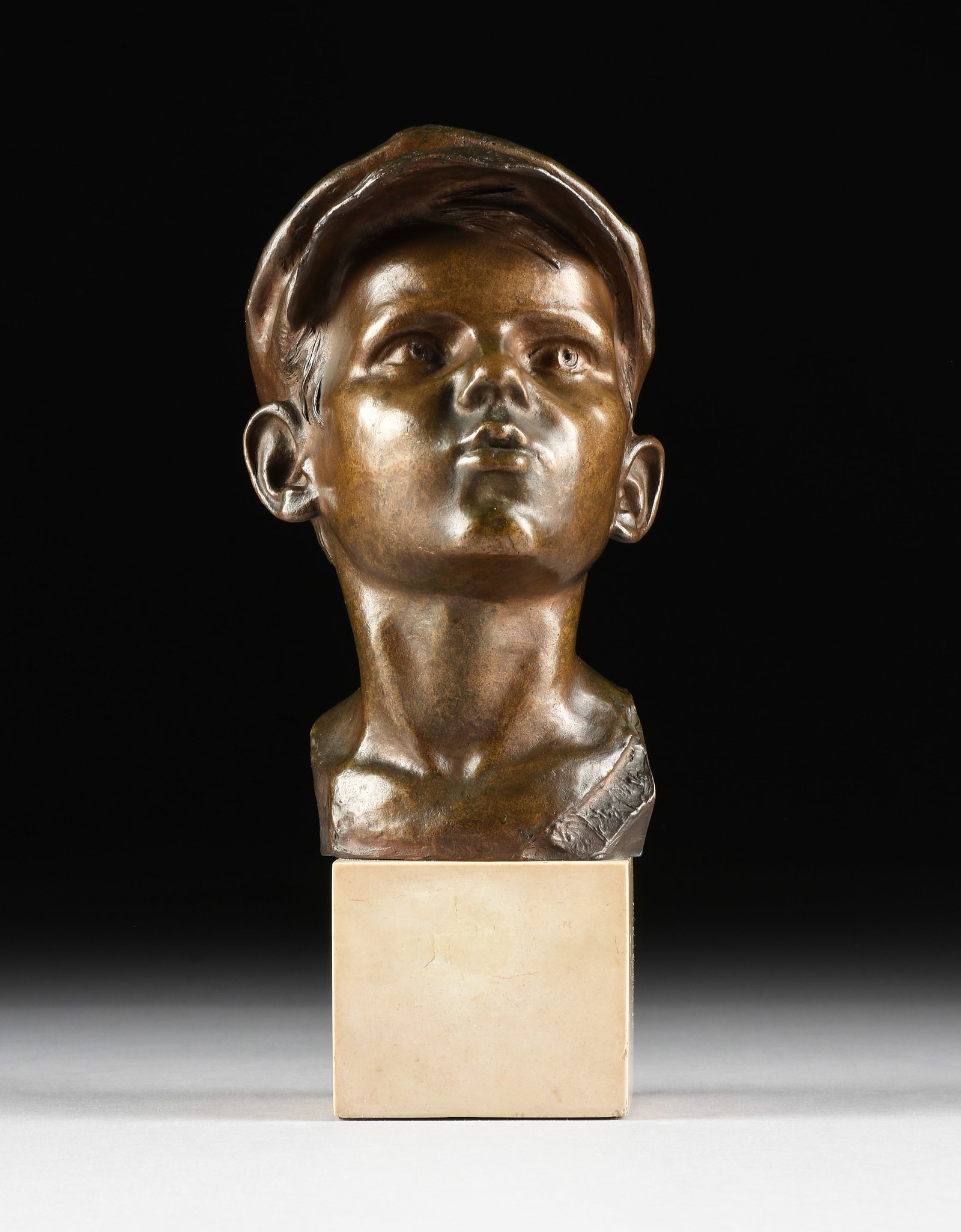 GIOVANNI DE MARTINO (Italian 1870-1938) "Boy with Cap," EARLY 20TH CENTURY,: GIOVANNI DE MARTINO (Italian 1870-1938) "Boy with Cap," EARLY 20TH CENTURY, patinated bronze bust of a boy mounted on a marble base, signed at right, "G.D. Martino." 14 x 6 1/2 x 8 in. (35.6 x 16.5 x 