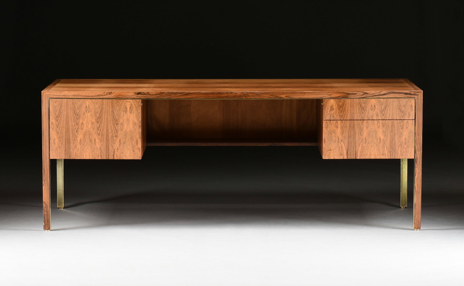 A WALNUT DESK, AMERICAN, 1970s,: A WALNUT DESK, AMERICAN, 1970s, mid-century modern three drawer walnut desk with a filing drawer on the left and two smaller drawers on the right. 29 x 78 x 36 in. (73.7 x 198.1 x 91.4 cm.) Provenance