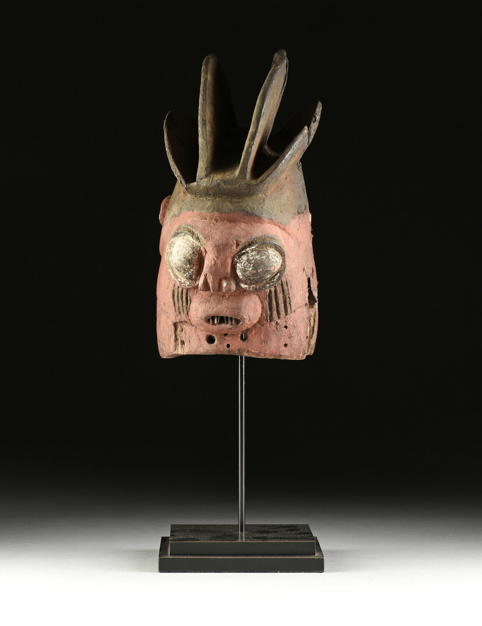 AN AFRICAN DUAL-SIDED MASK, PROBABLY EKITI REGION, NIGERIA, MID 20TH CENTURY,: AN AFRICAN DUAL-SIDED MASK, PROBABLY EKITI REGION, NIGERIA, MID 20TH CENTURY, painted wood, the quadruple crested helmet with bulging circular eyes and fanged teeth within scarred cheeks, the face