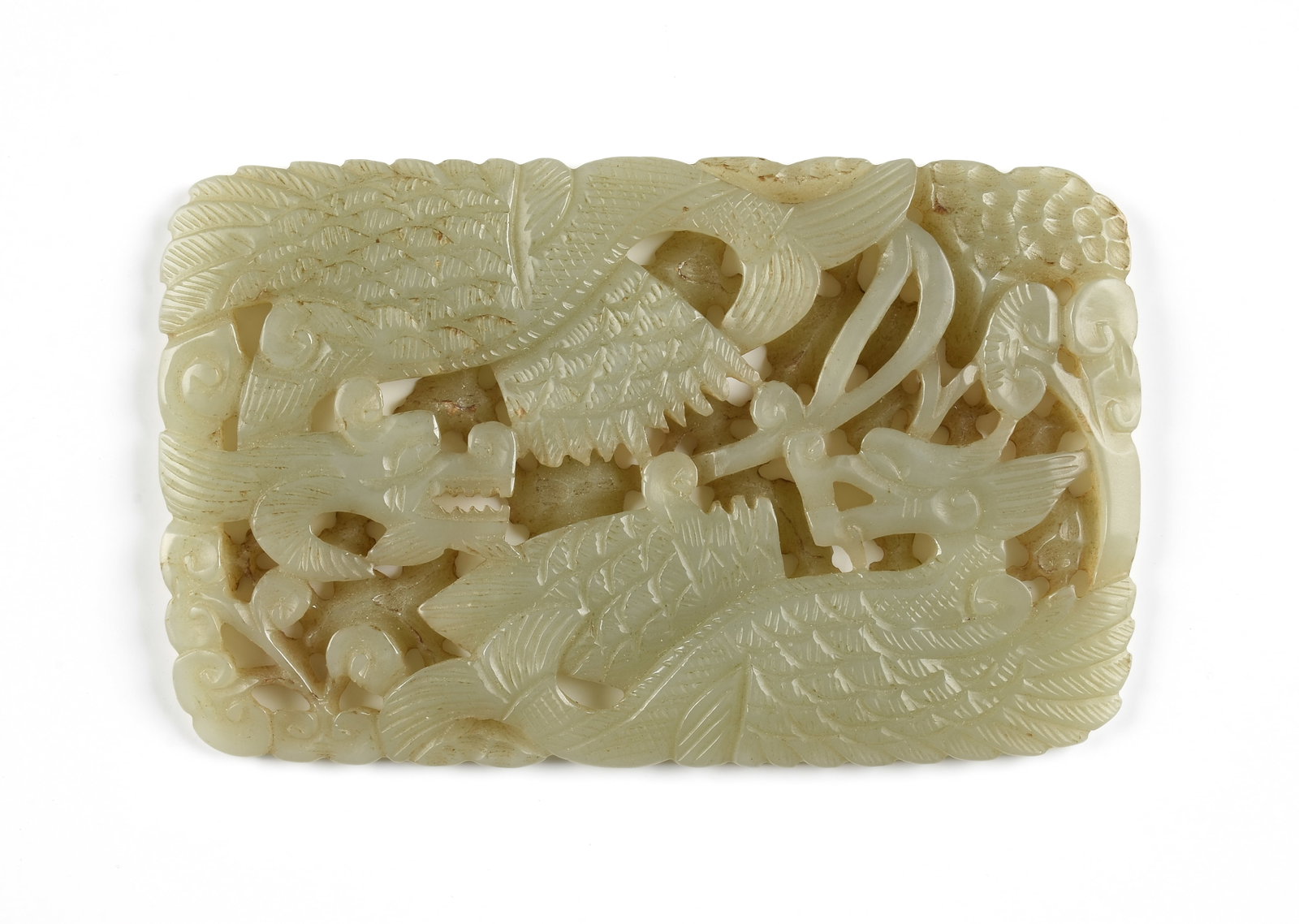 A JADE PLAQUE WITH MYTHIC BEASTS, CHINESE,: A JADE PLAQUE WITH MYTHIC BEASTS, CHINESE, a carved jade plaque with two winged beasts and mushrooms. View 360° in natural light … 2 1/8 x 4 1/8 in. (5.4 x 10.5 cm.) Provenance: Private