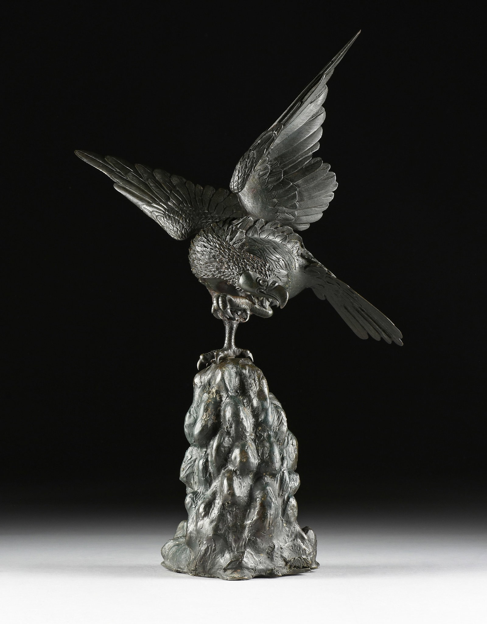 A BRONZE EAGLE SCULPTURE, 20TH CENTURY,: A BRONZE EAGLE SCULPTURE, 20TH CENTURY, patinated bronze. Height: 24 in. (61 cm.) Provenance: Collection of Dennis Miller, Galveston, Texas.