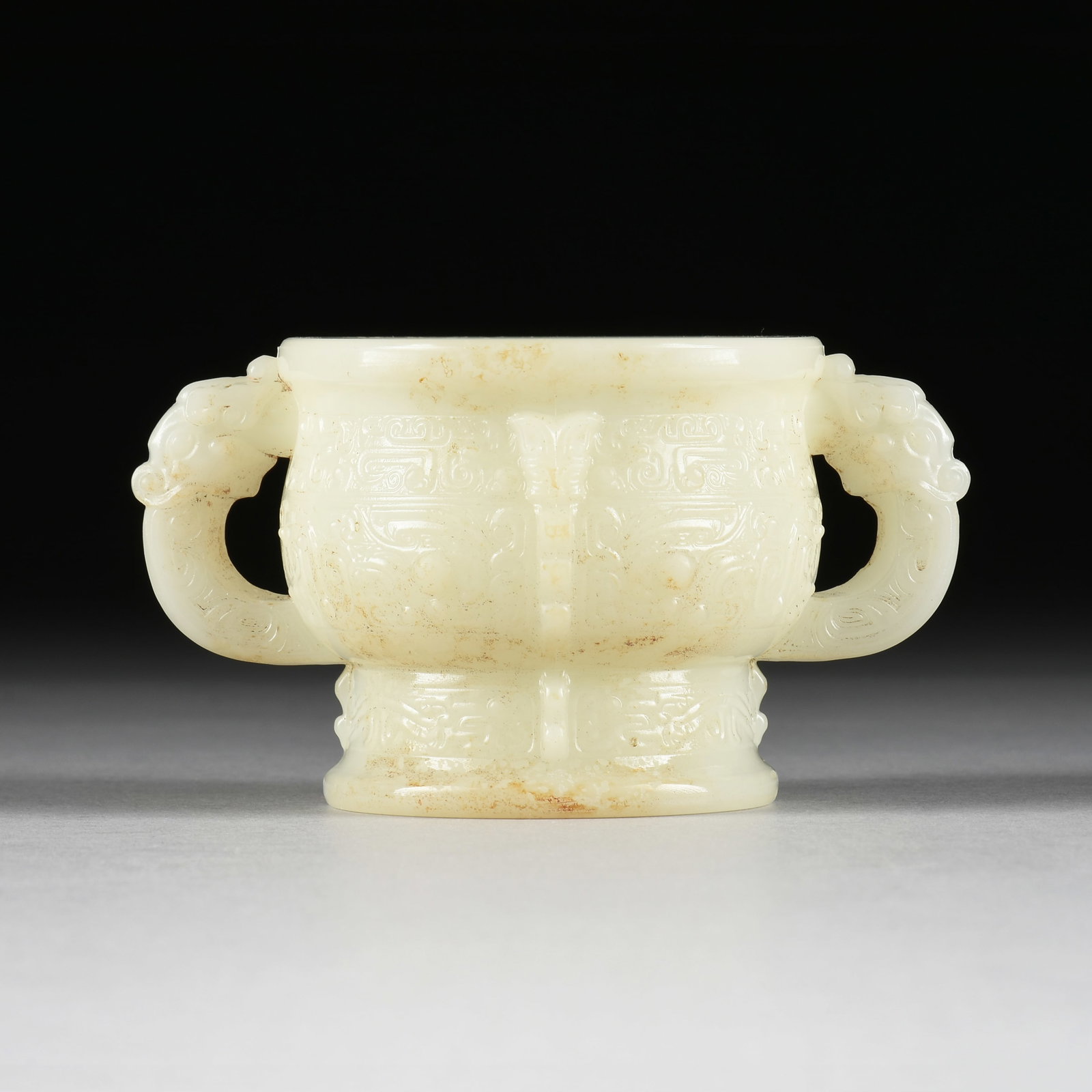 A JADE INCENSE BURNER, CHINESE, 20TH CENTURY,: A JADE INCENSE BURNER, CHINESE, 20TH CENTURY, two-handled jade vessel with incised stylized designs. View 360° in natural light &