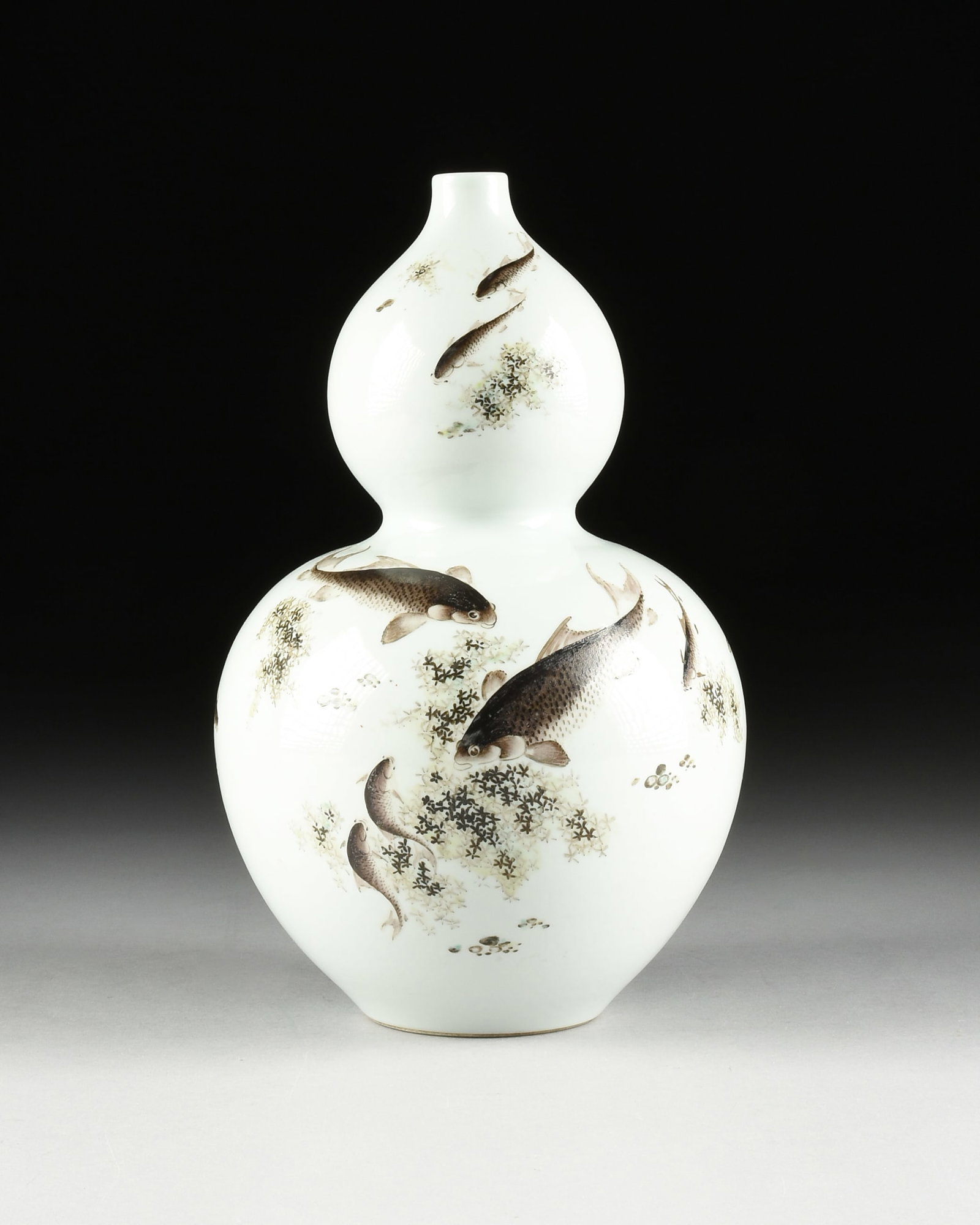 A DOUBLE GOURD FISH VASE, CHINESE, 20TH CENTURY,: A DOUBLE GOURD FISH VASE, CHINESE, 20TH CENTURY, hand-painted porcelain vase decorated with swimming fish, with a poem on the back, and with an apocryphal Qianlong reign mark on underside. 15 x 9 1/4 