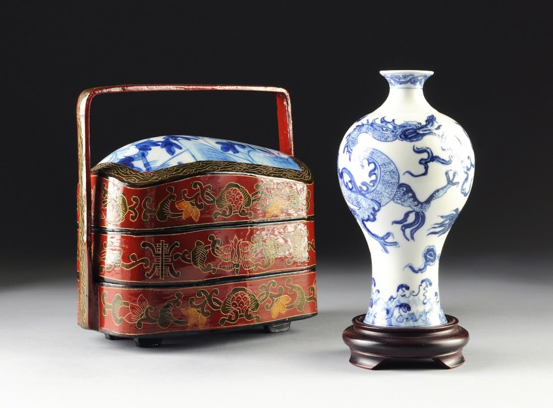 A CHINESE BLUE AND WHITE PORCELAIN VASE TOGETHER WITH A: A CHINESE BLUE AND WHITE PORCELAIN VASE TOGETHER WITH A BLUE AND WHITE MOUNTED THREE TIER LACQUER LUNCH BASKET, the bottle form vase with sides centering a sinuous three-claw dragon amongst stylized s