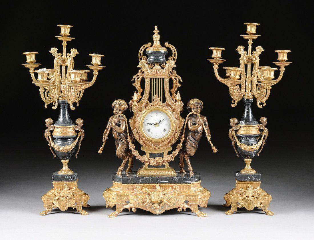 A THREE PIECE LOUIS XV STYLE ITALIAN MARBLE AND GILT ME: A THREE PIECE LOUIS XV STYLE ITALIAN MARBLE AND GILT METAL SEVEN-LIGHT CLOCK GARNITURE SET, 20TH CENTURY, comprised of a lyre form clock body with marble urn finial topped with rooster masks in relief