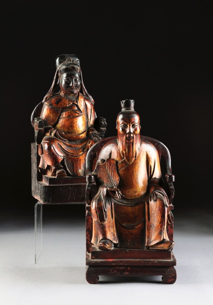 TWO ANTIQUE LACQUERED AND CARVED ALTAR FIGURES, LATE 19: TWO ANTIQUE LACQUERED AND CARVED ALTAR FIGURES, LATE 19TH/EARLY 20TH CENTURY, each modeled in a seated position in a traditional chair and wearing long flowing robes while holding a fan and another at