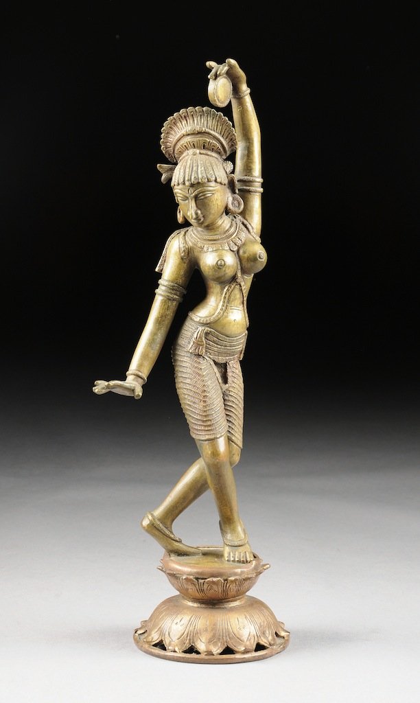 A PATINATED BRONZE FIGURE OF A DANCING HINDU MAIDEN, LA: A PATINATED BRONZE FIGURE OF A DANCING HINDU MAIDEN, LATE 20TH CENTURY, naturalistically modeled in a dancing position and scantily attired while holding a castanet above a stylized jeweled necklace, 