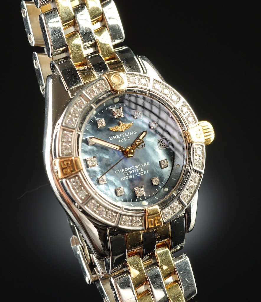 A BREITLING CALLISTINO 18K YELLOW GOLD, STAINLESS STEEL: A BREITLING CALLISTINO 18K YELLOW GOLD, STAINLESS STEEL, AND DIAMOND LADY'S WRISTWATCH, with quartz movement, mother-of-pearl dial, with diamond hour markers and diamond bezel, with two tone crosswind