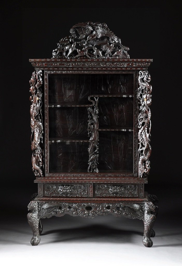 A VINTAGE CHINESE CARVED HARDWOOD VITRINE, REPUBLIC PER: A VINTAGE CHINESE CARVED HARDWOOD VITRINE, REPUBLIC PERIOD (1912-1949), the arched reticulated cornice of birds amongst auspicious foliage and scrolling clouds flanked by qilons detailed corners, rect
