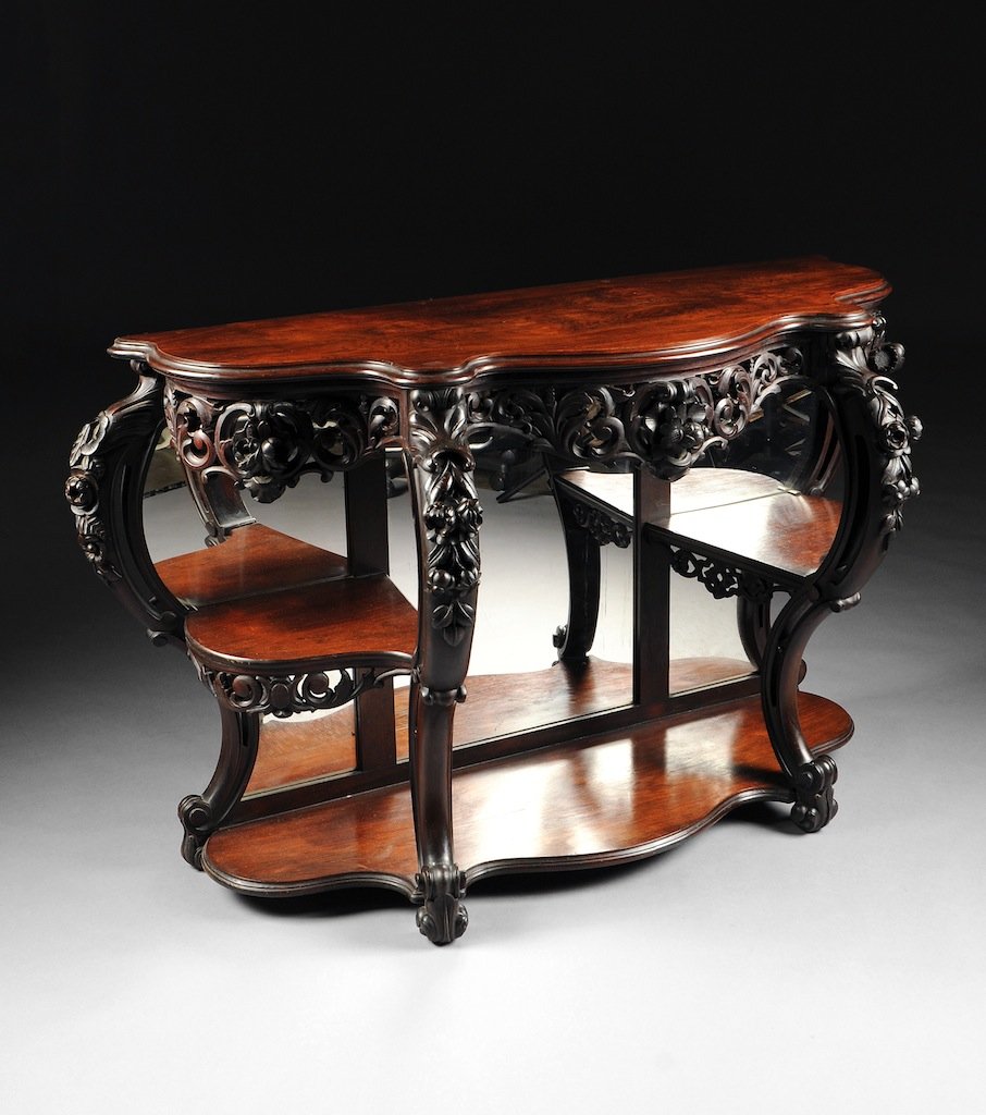 AN AMERICAN ROCOCO REVIVAL CARVED ROSEWOOD PIER CONSOLE: AN AMERICAN ROCOCO REVIVAL CARVED ROSEWOOD PIER CONSOLE, MID-19TH CENTURY, the serpentine demilune top within molded trim above a reticulated apron of "C" scrolls and blossoming foliage, raised on pie