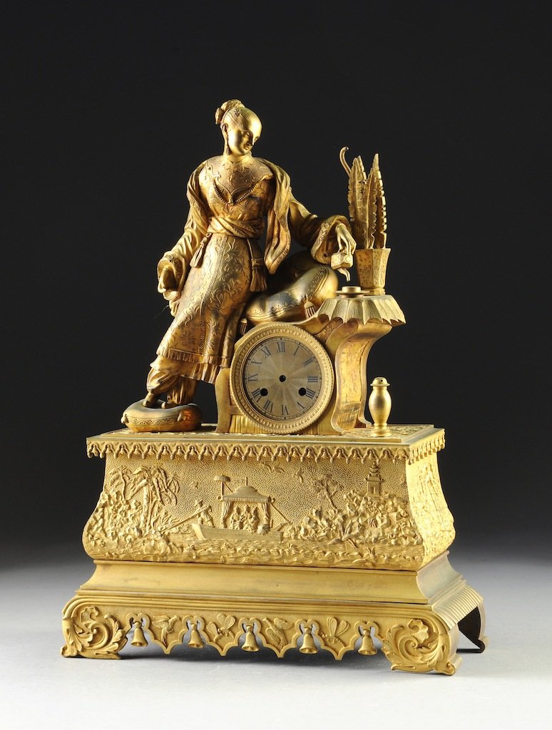 A LOUIS PHILIPPE CHINOISERIE GILT BRONZE MANTLE CLOCK,: A LOUIS PHILIPPE CHINOISERIE GILT BRONZE MANTLE CLOCK, CIRCA 1840, the circular dial with Roman chapters and twin key escapements within an egg and dart detailed beaded border and a bergère form case