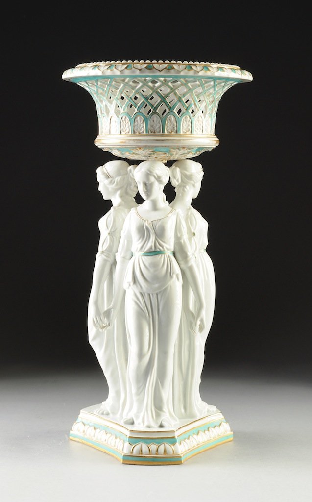 A NEOCLASSICAL STYLE PARCEL GILT TURQUOISE GROUND FIGUR: A NEOCLASSICAL STYLE PARCEL GILT TURQUOISE GROUND FIGURAL CENTERPIECE, LATE 19TH/EARLY 20TH CENTURY, in the Minton style with the three Graces holding hands and wearing classical attire, surmounted by