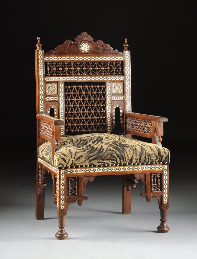 A SYRIAN MOTHER-OF-PEARL AND BONE INLAID CARVED WOOD: A SYRIAN MOTHER-OF-PEARL AND BONE INLAID CARVED WOOD ARMCHAIR, 20TH CENTURY, the scrolling arched crest rail centering an eight point star inlaid roundel within incised decoration, above a pierced rec