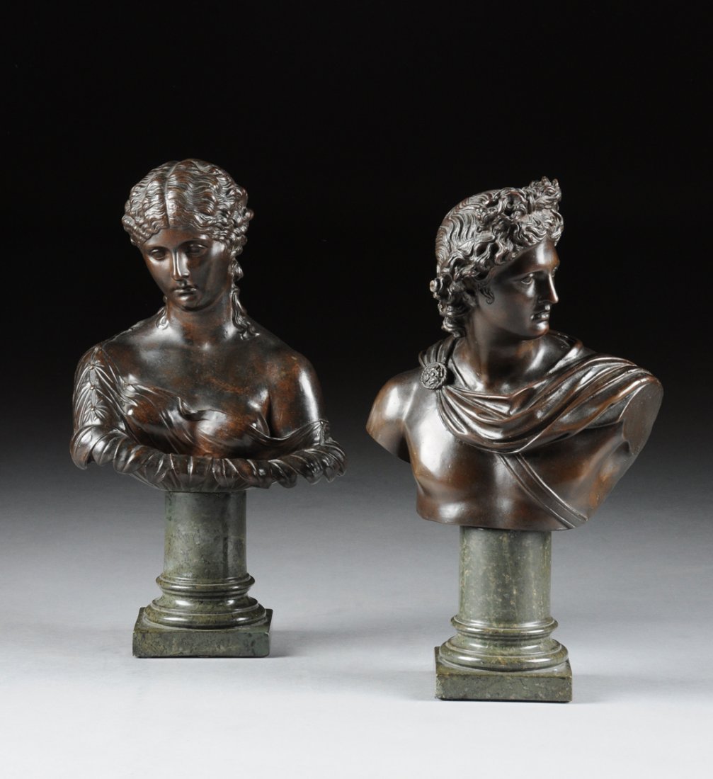 TWO CONTINENTAL PATINATED BRONZE BUSTS OF THE APOLLO: TWO CONTINENTAL PATINATED BRONZE BUSTS OF THE APOLLO BELVEDERE AND VENUS, POSSIBLY ITALIAN, LATE 19TH/EARLY 20TH CENTURY, each mounted on a green serpentine marble truncated columnar pedestal. NOTE: t