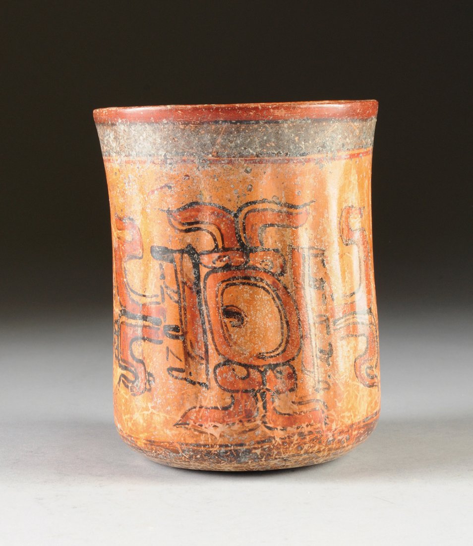 A MAYAN POLYCHROME PAINTED POTTERY CEREMONIAL VESSEL,: A MAYAN POLYCHROME PAINTED POTTERY CEREMONIAL VESSEL, LATE CLASSIC PERIOD, CIRCA A.D. 550-950, of slightly waisted cylindrical form with remnants of a bright blue banded rim and foot, enclosing fluted