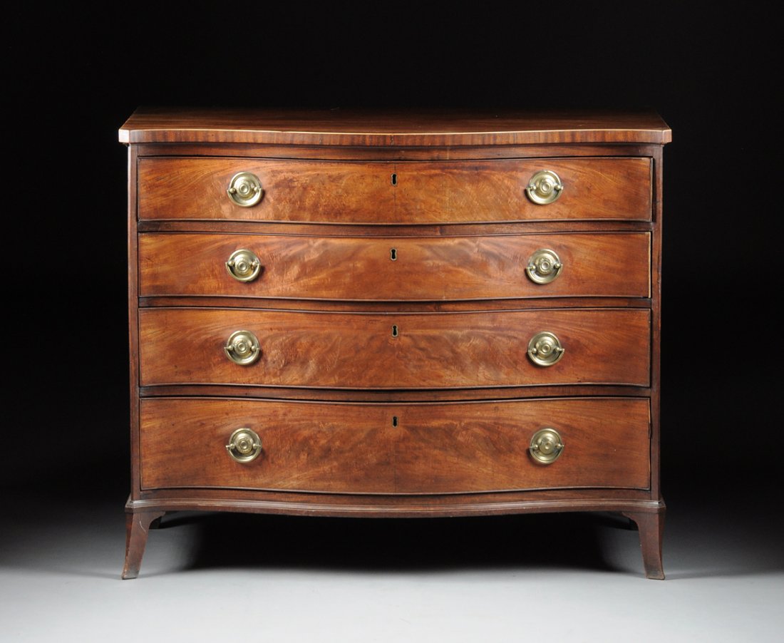 AN EXCEPTIONAL GEORGE III MAHOGANY GENTLEMAN'S DRESSING: AN EXCEPTIONAL GEORGE III MAHOGANY GENTLEMAN'S DRESSING CHEST OF DRAWERS, CIRCA 1790, in the Hepplewhite style, with a serpentine rectangular top above the first drawer, opening to a fitted interior c