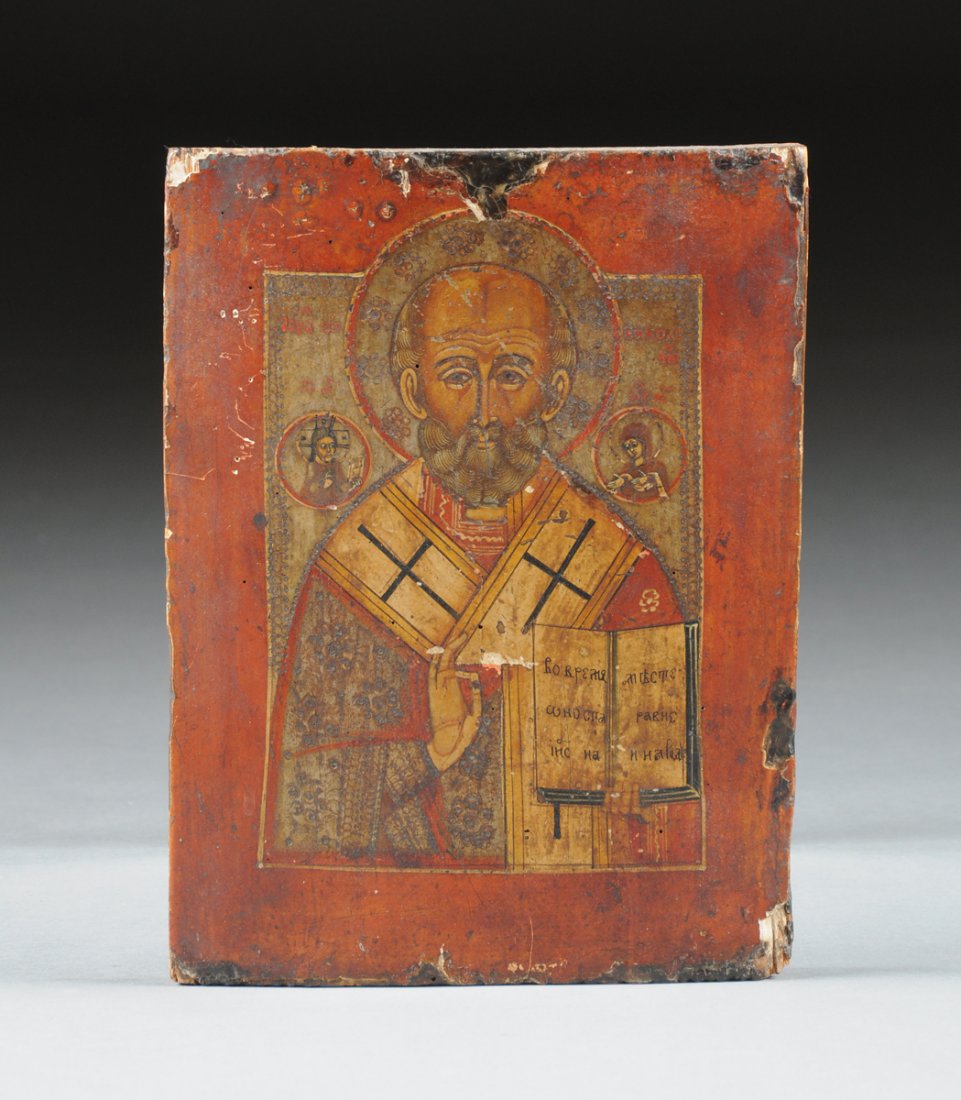 A RUSSIAN ICON OF ST. NICHOLAS, POSSIBLY 19TH CENTURY,: A RUSSIAN ICON OF ST. NICHOLAS, POSSIBLY 19TH CENTURY, painted in traditional polychrome tempura colors with silver as well as gold leaf details and depicting a three-quarter length St. Nicholas in lo