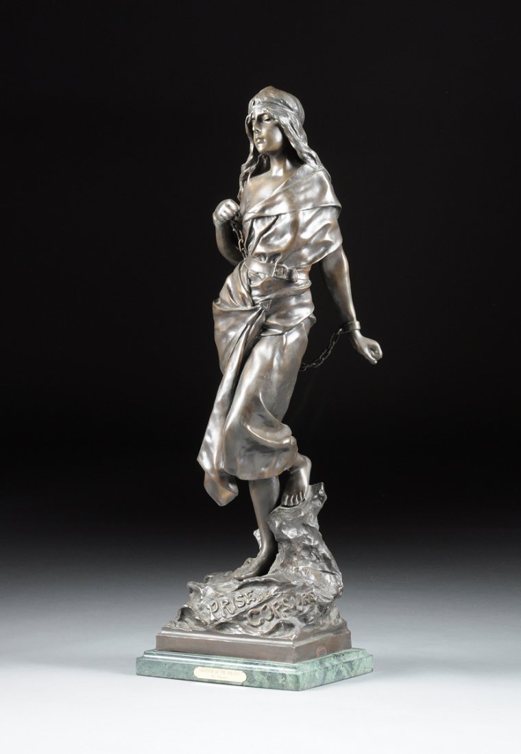 cast after a model by EMMANUEL VILLANIS (FRENCH: cast after a model by EMMANUEL VILLANIS (FRENCH 1858-1914) A PATINATED BRONZE SCULPTURE "PRISONER OF CORSAIRE," the maiden prisoner modeled with chained arms and standing on stylized groundwork, incis