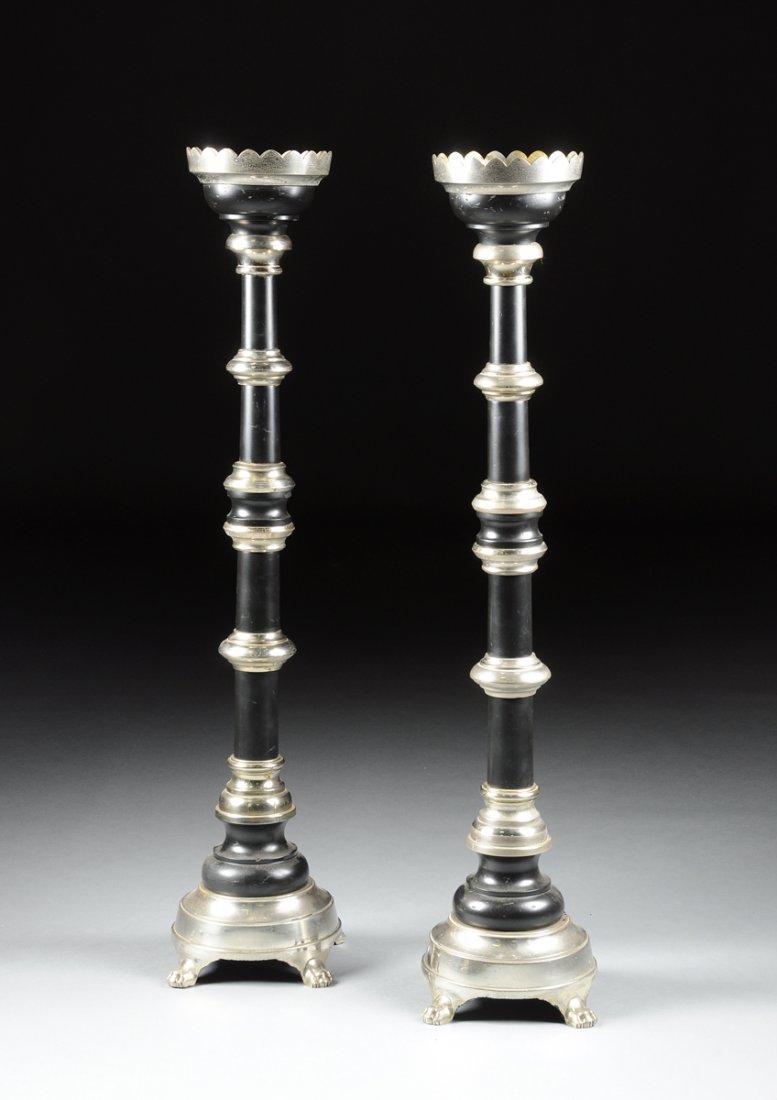 A PAIR OF CONTINENTAL CHROMED METAL AND EBONIZED WOOD: A PAIR OF CONTINENTAL CHROMED METAL AND EBONIZED WOOD TORCHÉRES, EARLY 20TH CENTURY, each with a scalloped rim above a columnar stem partitioned by conforming rings, on a similar base raised on styli