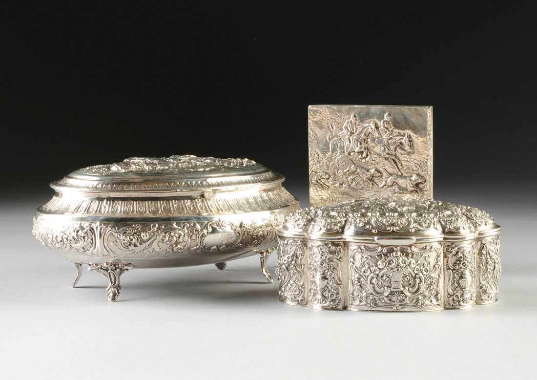 A GROUP OF THREE CONTINENTAL REPOUSSÃ‰ SILVER BOXES,: A GROUP OF THREE CONTINENTAL REPOUSSÃ‰ SILVER BOXES, GERMAN AND BELGIAN HALLMARKS, LATE 19TH AND POST 1942, comprising a German oval footed box with hinged lid centering a maiden shepherdess and at