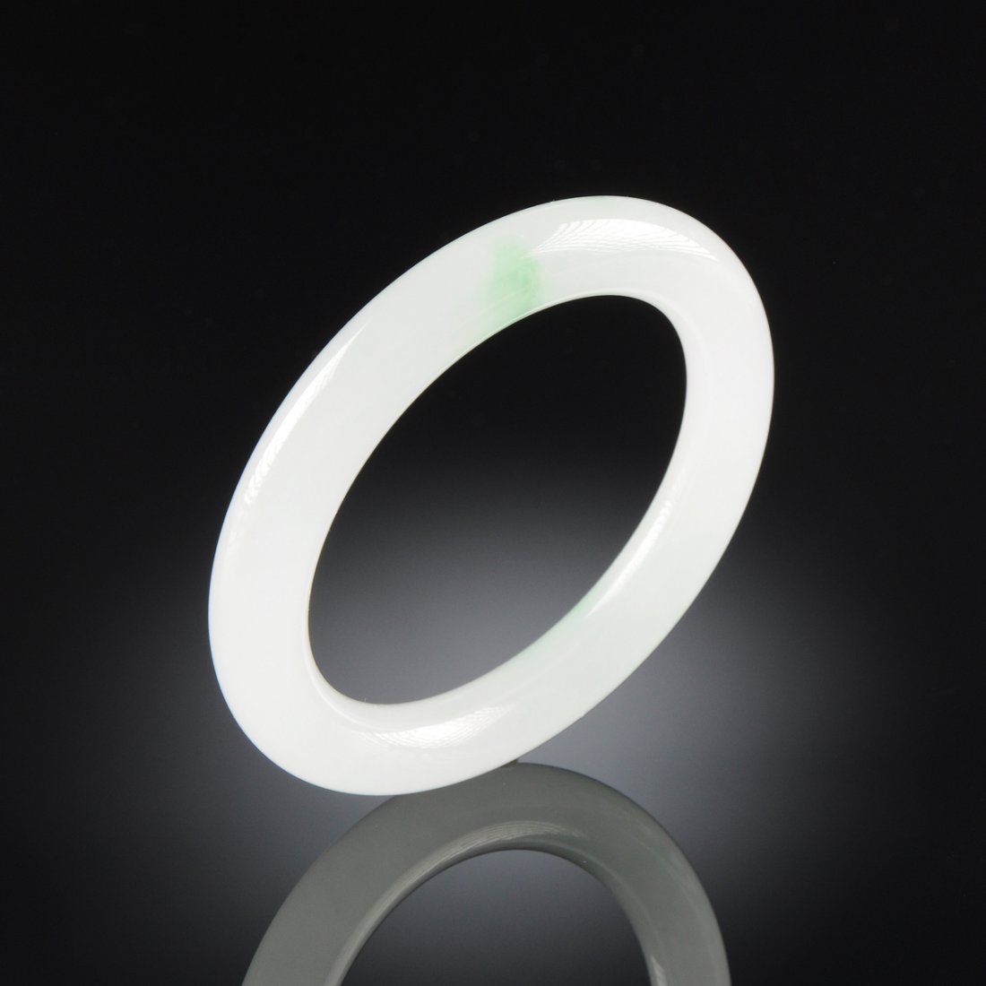 A CHINESE TRANSLUCENT WHITE AND APPLE GREEN BANGLE: A CHINESE TRANSLUCENT WHITE AND APPLE GREEN BANGLE BRACELET, MODERN, of traditional form, inside diameter: 2 1/8".