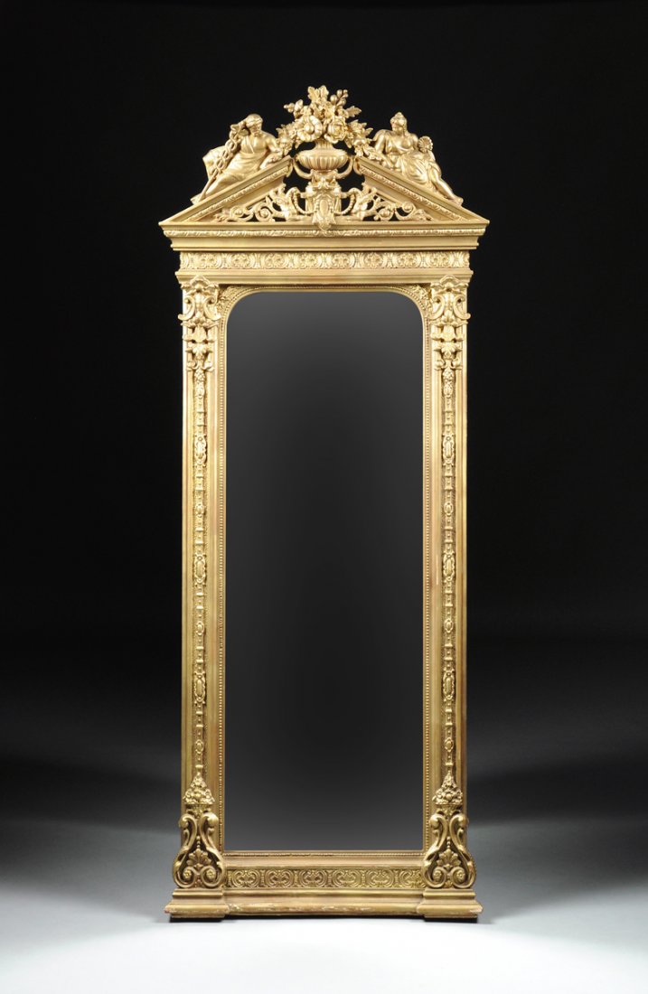 AN EDWARDIAN NEOCLASSICAL STYLE GOLD PAINTED PIER: AN EDWARDIAN NEOCLASSICAL STYLE GOLD PAINTED PIER MIRROR, LATE 19TH/EARLY 20TH CENTURY, the vertical rounded rectangular mirror within beaded trim, flanked by "C" scroll and tapered foliate modeled ca