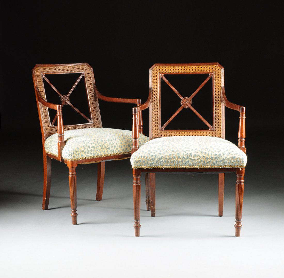 A PAIR OF REGENCY CANED AND CARVED MAHOGANY UPHOLSTERED: A PAIR OF REGENCY CANED AND CARVED MAHOGANY UPHOLSTERED ARMCHAIRS, EARLY 19TH CENTURY, each having a reticulated rectangular back with canted corners enclosing reeded “X” form stiles centering bel
