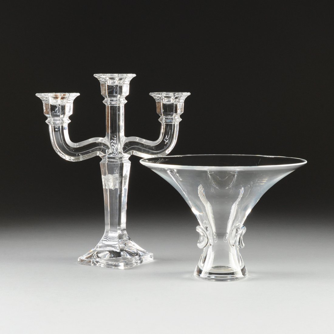 TWO CONTEMPORARY TRANSPARENT CRYSTAL WARES, LATE 20TH: TWO CONTEMPORARY TRANSPARENT CRYSTAL WARES, LATE 20TH CENTURY, comprising a Rosenthal Versace three-light candelabrum with a tapering rectangular columnar stem centering frosted Apollo masks in relief