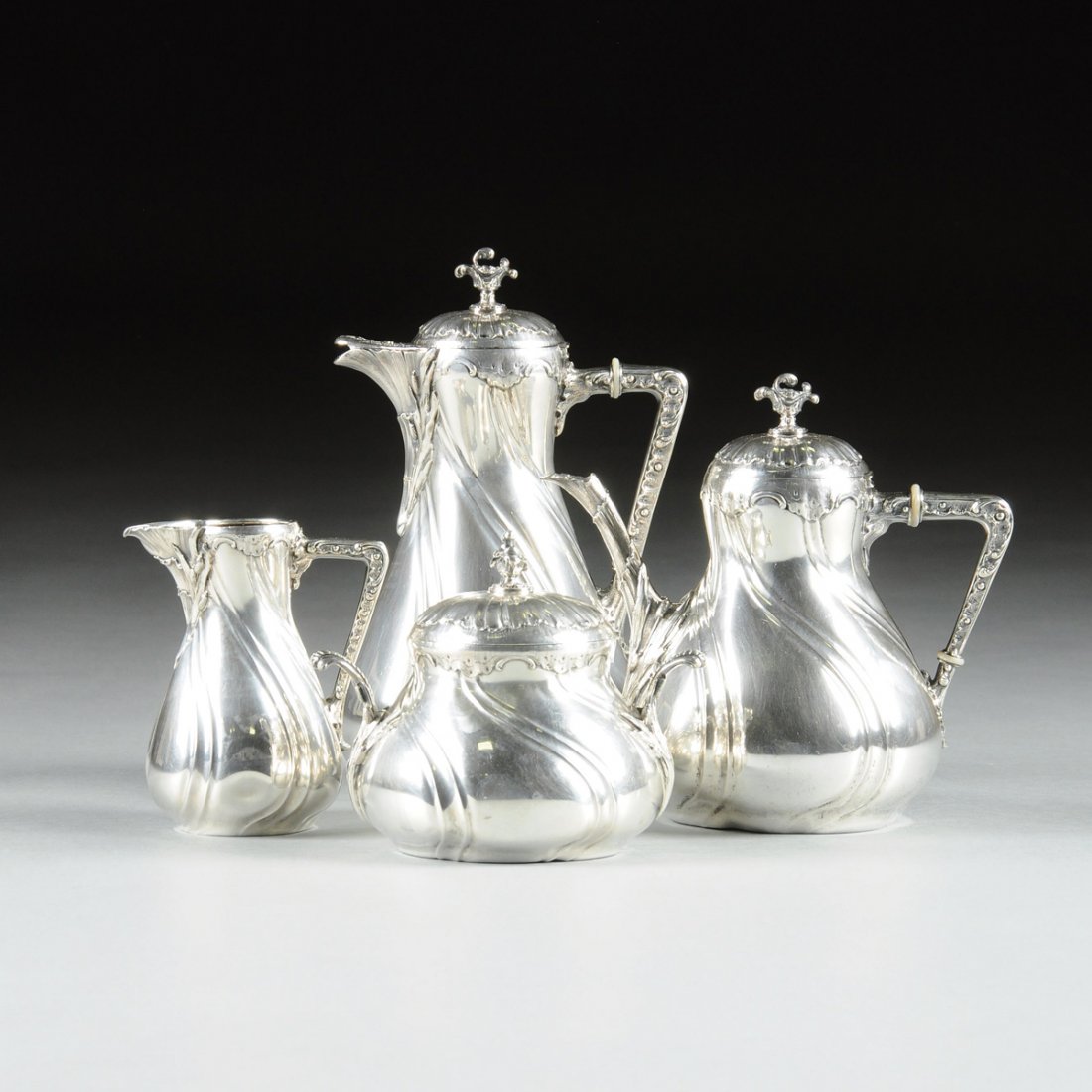 A WOLFERS FRÈRES FOUR PIECE 800 STANDARD SILVER COFFEE: A WOLFERS FRÈRES FOUR PIECE 800 STANDARD SILVER COFFEE AND TEA SERVICE FOR THE GERMAN MARKET, BRUSSELS, BELGIUM, LATE 19TH/EARLY 20TH CENTURY the set comprising a coffee pot with hinged lid, teapot w