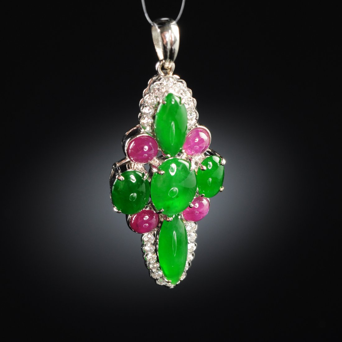 AN 18K WHITE GOLD CHINESE "A" JADEITE JADE, RUBY,: AN 18K WHITE GOLD CHINESE "A" JADEITE JADE, RUBY, DIAMOND LADY"S PENDANT, in a setting with five natural, type “A” jadeite jade cabochons measuring approximately 6.2 x 4.0 to 9.40 x 4.76 millimete