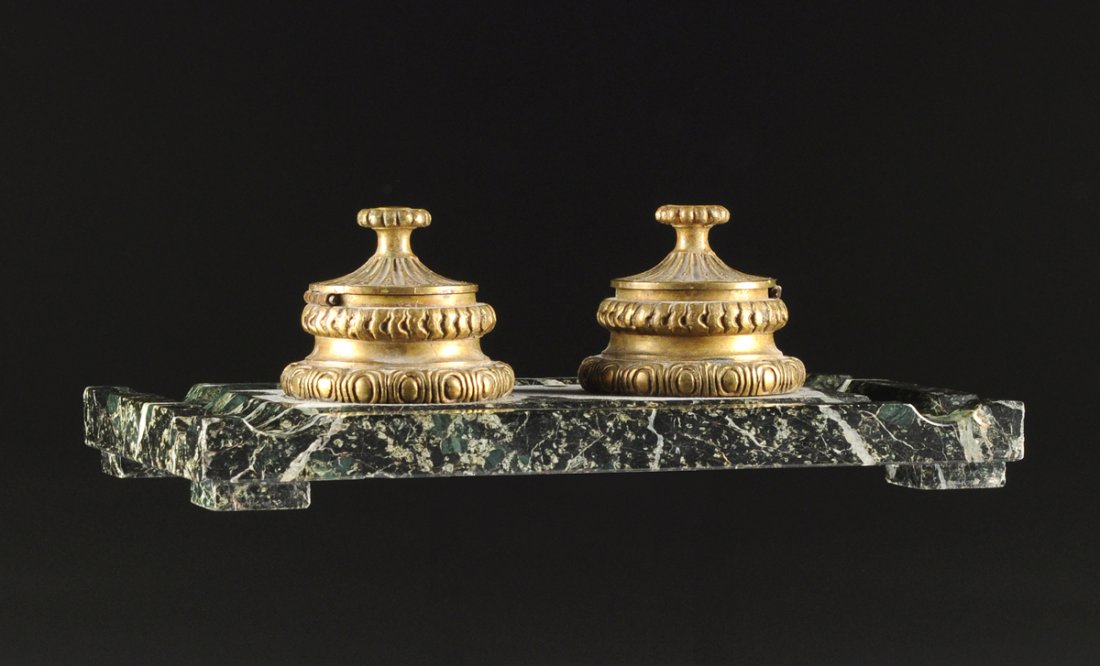 A NAPOLEON III GILT BRONZE MOUNTED VERDE ANTICO: A NAPOLEON III GILT BRONZE MOUNTED VERDE ANTICO ENCRIER, THIRD QUARTER 19TH CENTURY, of flat rectangular form with block feet, enclosing conforming pen troughs centering a pair of circular waisted ink