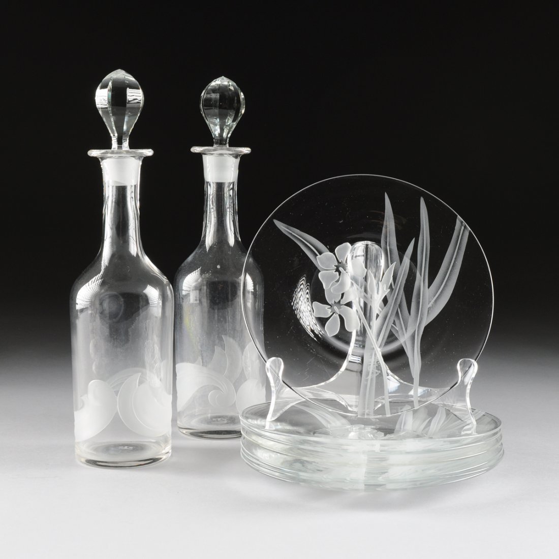 A GROUP OF NINE DOROTHY C. THORPE SANDBLASTED CRYSTAL: A GROUP OF NINE DOROTHY C. THORPE SANDBLASTED CRYSTAL ITEMS, LOS ANGELES, CALIFORNIA, CIRCA 1950, comprising a pair of bottle form clear crystal decanters with sandblasted addorsed foliate scroll deco