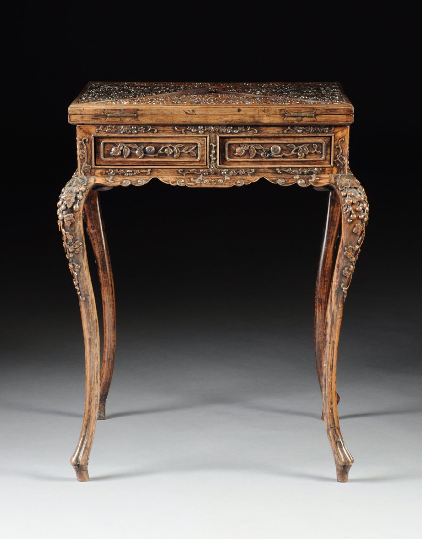 A VINTAGE CHINESE CARVED HARDWOOD HANDKERCHIEF GAMES: A VINTAGE CHINESE CARVED HARDWOOD HANDKERCHIEF GAMES TABLE, REPUBLIC PERIOD (1912-1949), the rectangular swivel top centering triangular hinged leaves enclosing roaring four claw dragons clutching ree