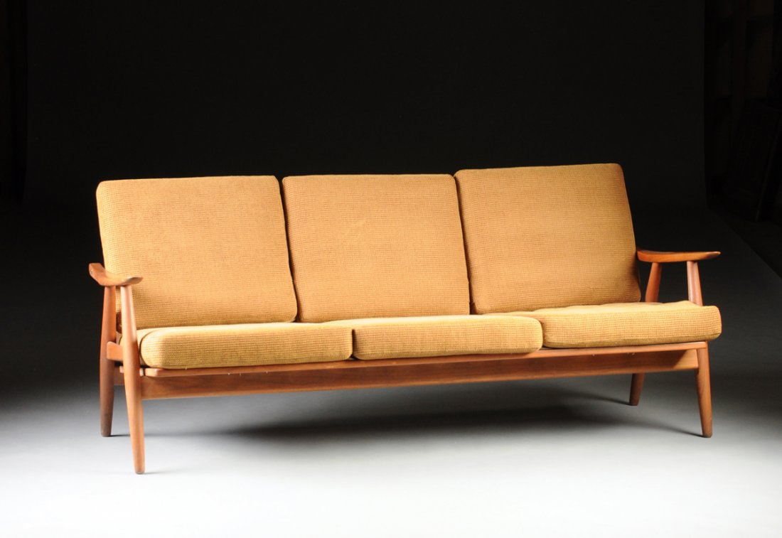 A HANS WEGNER (DANISH 1914-2007) MODEL GE-270/3: A HANS WEGNER (DANISH 1914-2007) MODEL GE-270/3 THREE-SEAT TEAK SOFA, DESIGNED 1954, MANUFACTURED BY GETAMA, GEDSTED, DEMARK, CIRCA 1960, with cigar shape legs, gently curved tapered arms, open back w