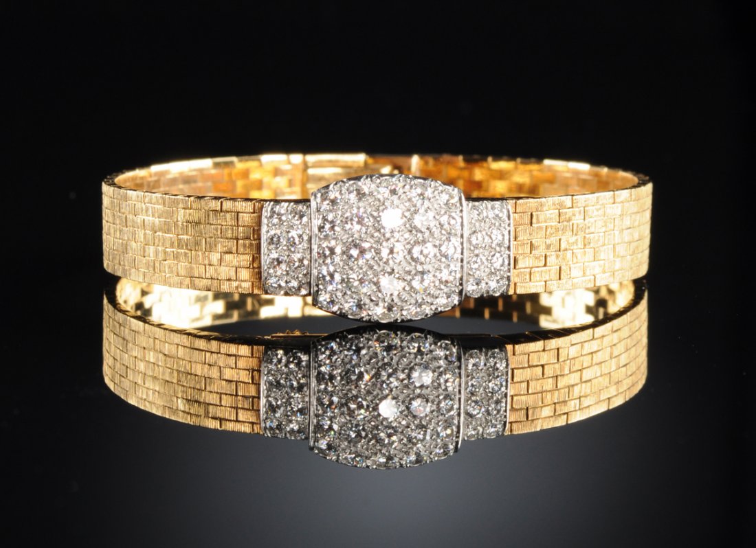 AN 18K YELLOW GOLD AND DIAMOND AUDEMARS PIGUET LADY'S: AN 18K YELLOW GOLD AND DIAMOND AUDEMARS PIGUET LADY'S WATCH, set with sixteen round diamonds with an approximate weight of .50 Cts and twenty-five round diamonds with an approximate weight of 1.00 Cts