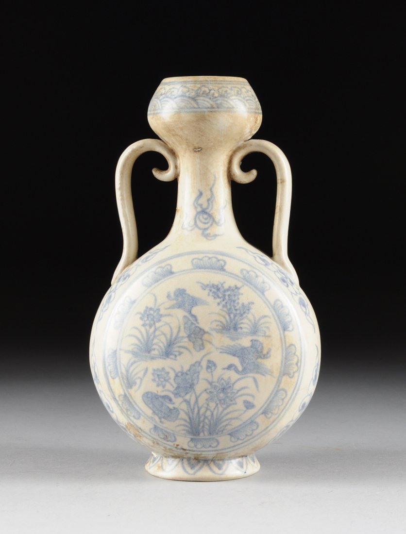 A VIETNAMESE/ANNAMESE BLUE AND WHITE TWO-HANDLED MOON: A VIETNAMESE/ANNAMESE BLUE AND WHITE TWO-HANDLED MOON VASE, of slightly compressed "moon" form with sides centering marsh fowl amongst auspicious blossoming foliage within double ring and leaf painted