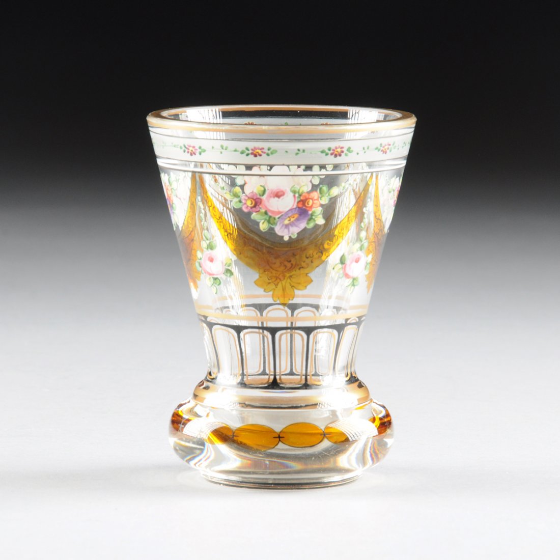 A BIEDERMEIER CLEAR GLASS BEAKER WITH POLYCHROME: A BIEDERMEIER CLEAR GLASS BEAKER WITH POLYCHROME ENAMEL, GILT, AND FLASHED AMBER DECORATION, PROBABLY BUDAPEST, HUNGARY, CIRCA 1835, the trumpet form beaker on cushion form foot with polychrome enamel