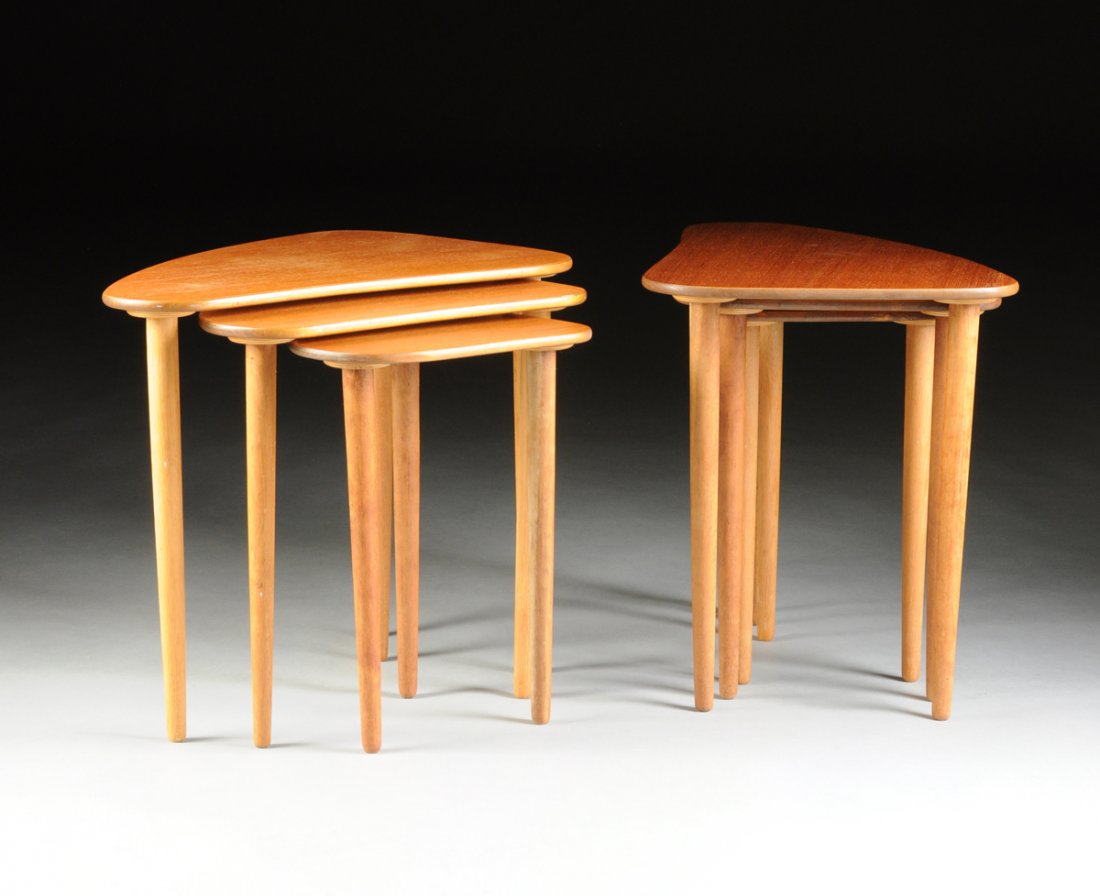 A GROUP OF TWO DANISH THREE PIECE TEAK NESTING TABLES,: A GROUP OF TWO DANISH THREE PIECE TEAK NESTING TABLES, CIRCA 1960, of graduated "boomerang" form ,each raised on three tapered screw-in legs and stamped to the bottom "MADE IN DENMARK, N.F.C. 103." He