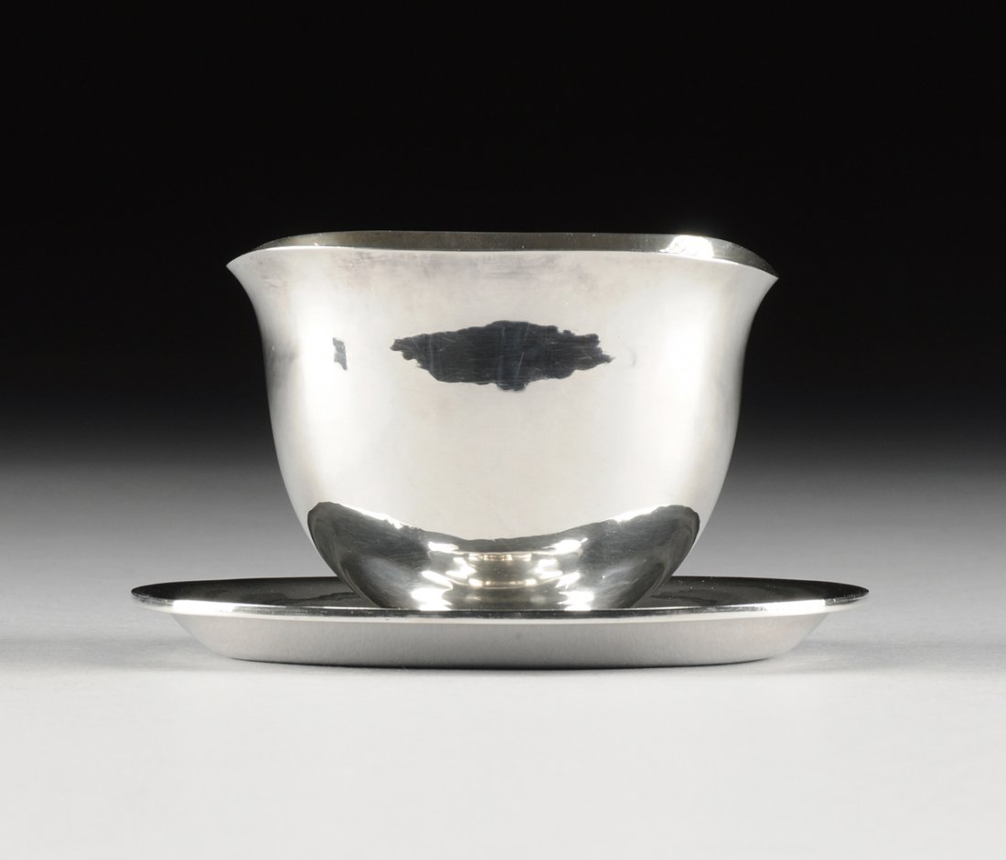 KARL GUSTAV HANSEN (Danish 1925-1994) A STERLING SILVER: KARL GUSTAV HANSEN (Danish 1925-1994) A STERLING SILVER SAUCE BOAT AND UNDER TRAY, FOR HANS HANSEN, COPENHAGEN, DENMARK, 1961, of tall ovoid form with everted lip, the attached oval under trap with wh